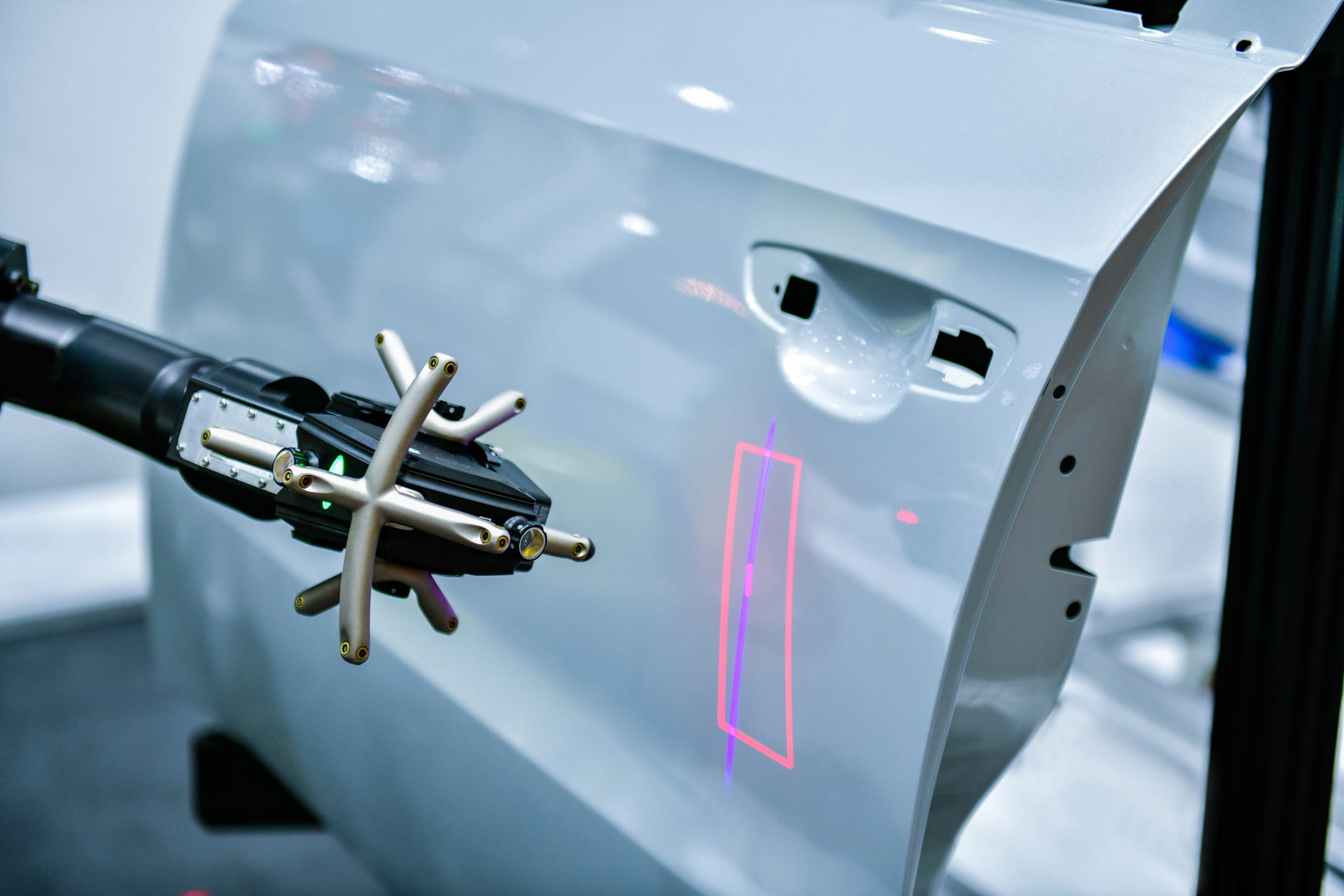 robotic arm with multi-sensor 3d scanner using laser measurement technology to inspect automotive door panel for dimensional accuracy and defect detection in automated quality control processes