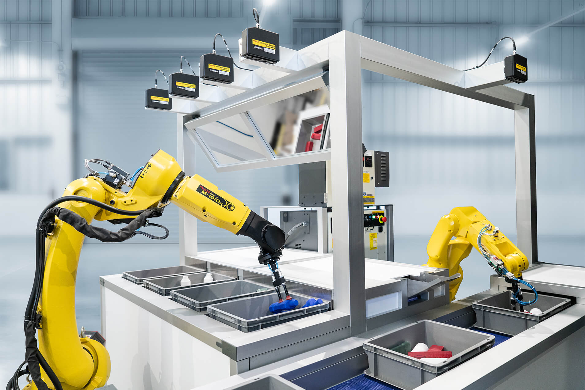 Image of two fanuc robotic arms performing picking and placing function