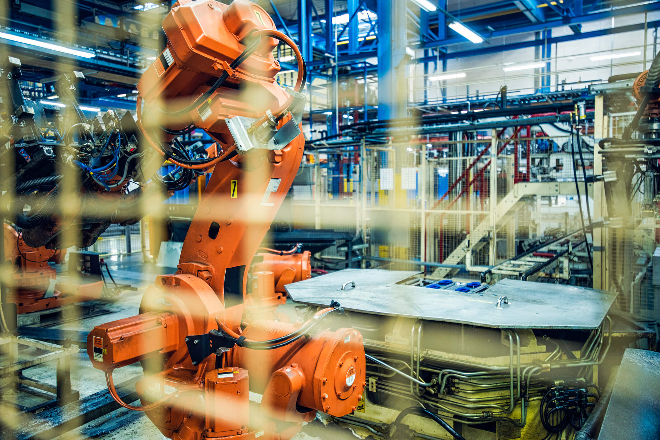 industrial-robot-operating-behind-safety