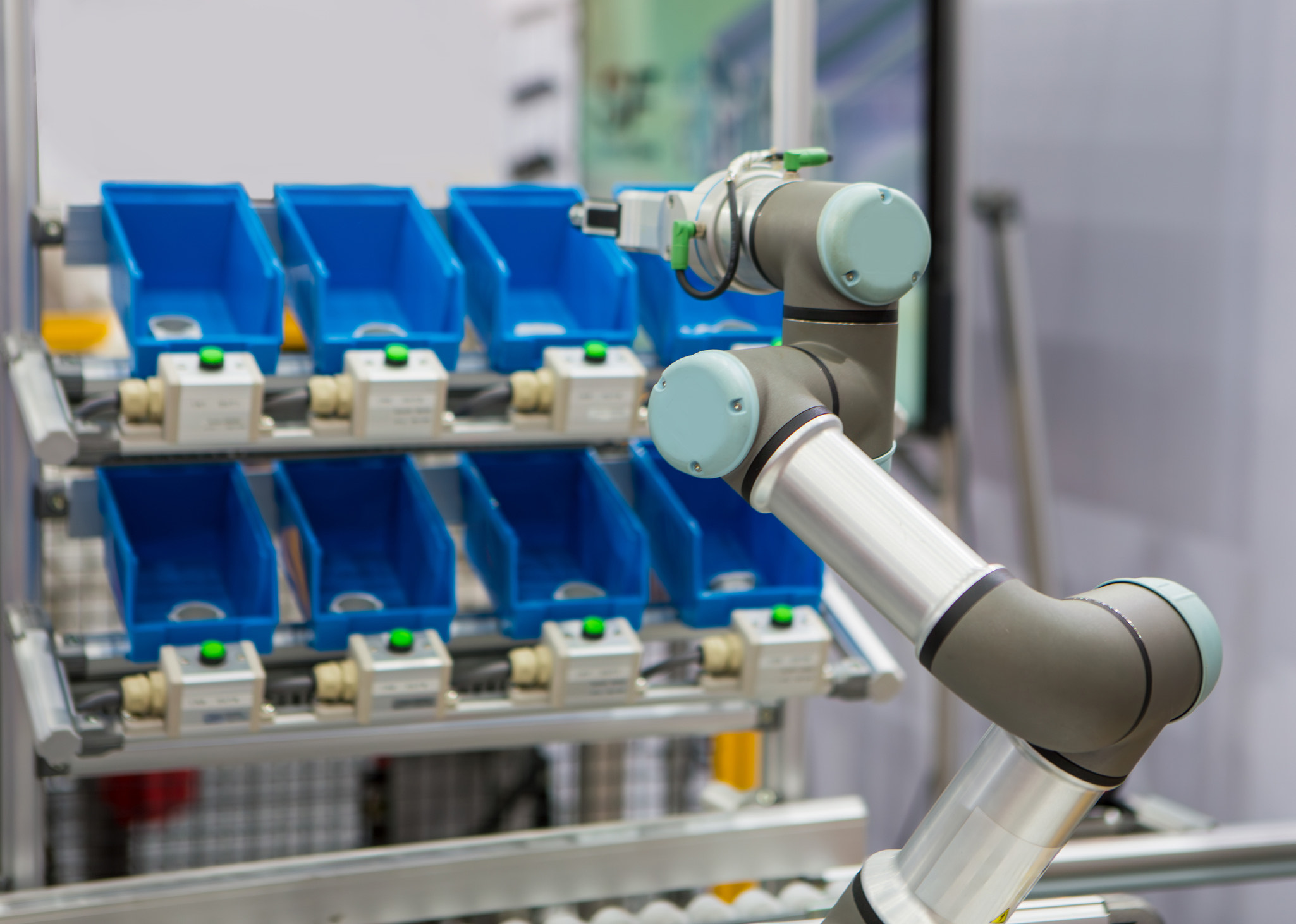 an automated robotic arm picking parts from assorted bins